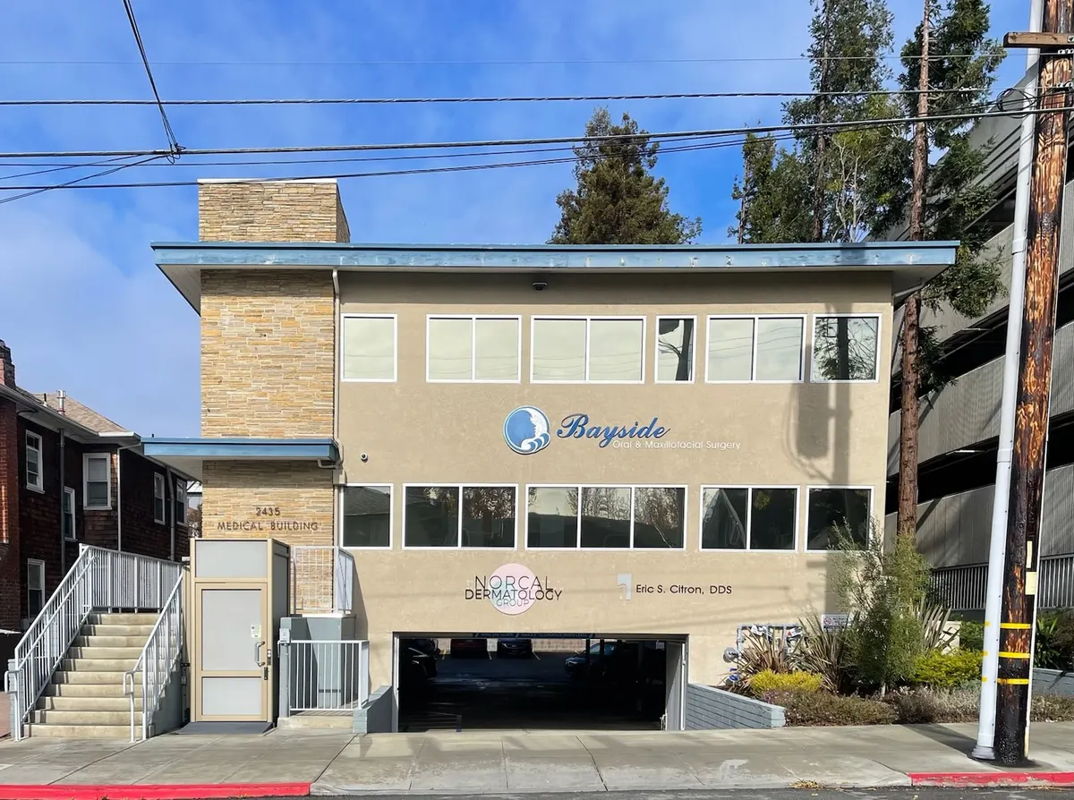 Exterior of the two-story 2435 Medical Building in Berkeley, with a NorCal Dermatology Group sign on the front wall above the garage entrance.